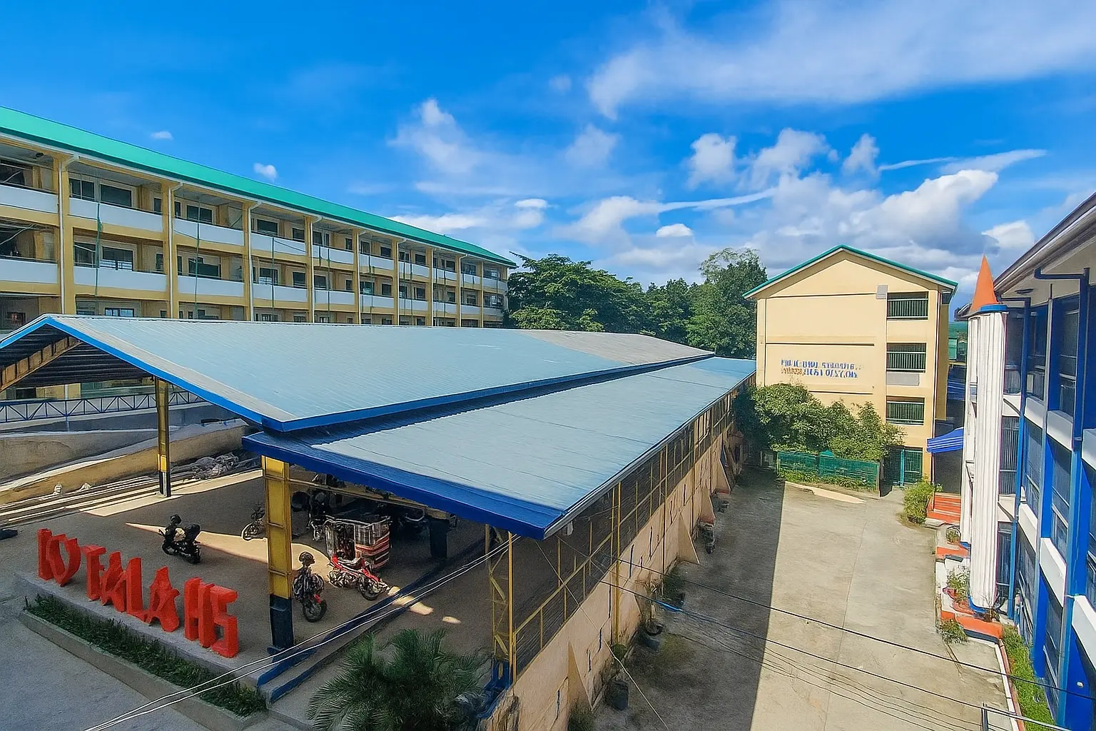 Tala High School campus under a bright blue sky